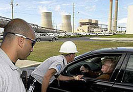 Nuclear facility guards challenging a visitor in a vehicle