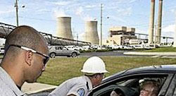 image of 10 CFR Part 73 Physical Protection with a personel protecting the power plant in the background and gate wire in view