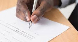 image of Licensing Actions with a person signing a document