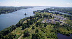 image of Decommissioning of Nuclear Facilities with a view from the sky of tree and open green space along a river where a now decommissioned plant once stood