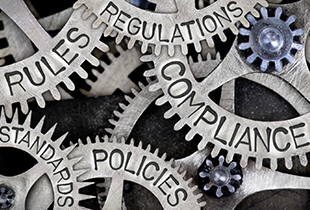 Image of gears with the words 'Rules', 'Regulations', 'Standards', 'Policies', and 'Compliance'
