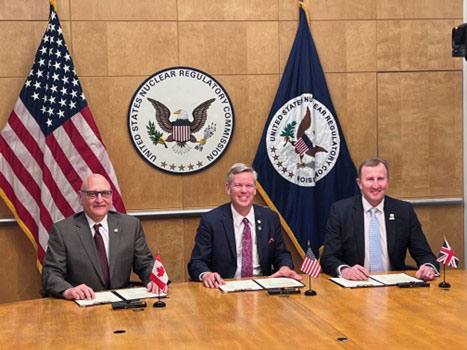 Image of CNSC Executive Vice President Ramzii Jammal, USNRC Chair Christopher Hanson, and UK ONR  Chief Executive Mark Foy sign the Memorandum of Cooperation for Advanced Reactors and Small Modular Reactors. 