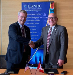 Image of USNRC EDO Dan Dorman and CNSC Executive Vice President Ramzii Jammal sign an agreement to collaborate on reviews of the BWRX-300 SMR