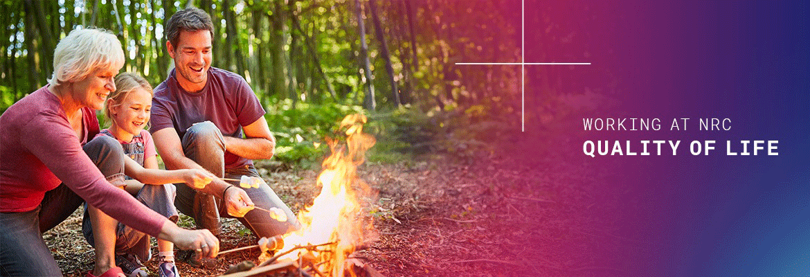 family in front a camp fire roasting marshmallows, to the right is a purple and faded into blue colored background, with the words 'working at nrc' and (in bold font) 'quality of life' 