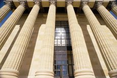 Front side of a building with a brown door at the center and big columns in front (hyperlink to Rulemaking page) 