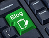 image of a green-colored enter key on a computer keyboard with the word Blog in white and below, a white outline of a notepad with a pencil