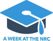 A blue graduation cap with the words 'A WEEK AT THE NRC' written underneath in blue font