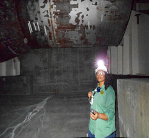 An NRC Inspector verifies dose rates in a steam generator mausoleum at a nuclear power site.