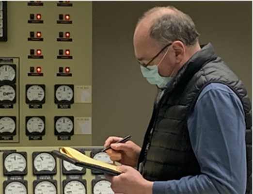 Picture of reactor operator completing examination