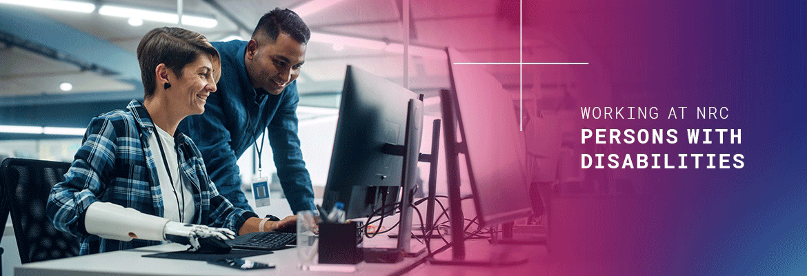 a woman employee at desk with a robotic arm using a computer mouse with a male employee viewing the screen, and to the right on a purple and faded into blue colored background with the words 'working at nrc' and (in bold font) 'persons with disabilities'