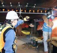 Image of personnel overseeing construction.