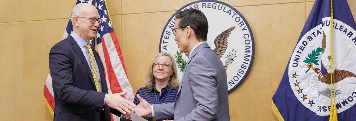 Chairman Ho Nieh, right, congratulates Commissioner Doug Weaver, left, after administering the oath of office during a swearing-in ceremony at the U.S. Nuclear Regulatory Commission headquarters in Rockville, Md. 