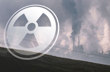 an image of a nuclear facility with a translucent radiation symbol in front