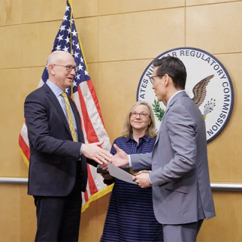 Chairman Ho Nieh, right, congratulates Commissioner Doug Weaver, left, after administering the oath of office during a swearing-in ceremony at the U.S. Nuclear Regulatory Commission headquarters in Rockville, Md. 